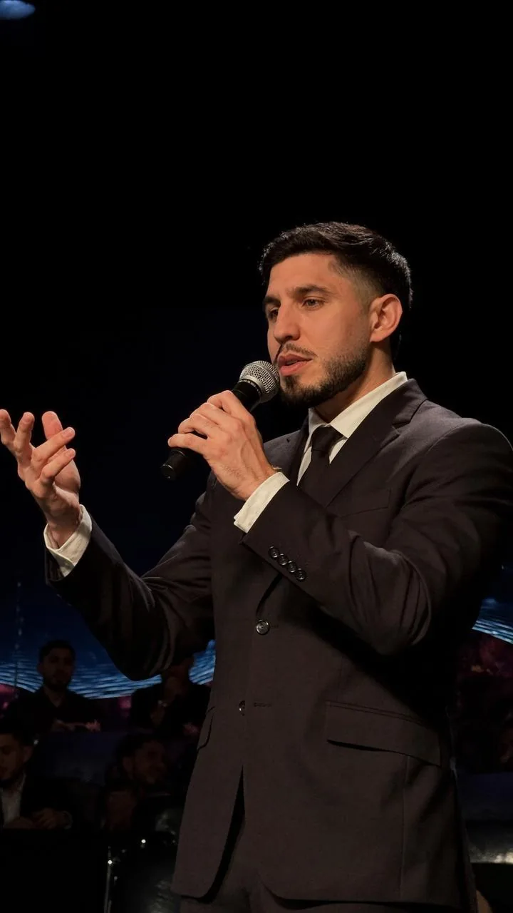 Nikkolas Pena speaking on stage